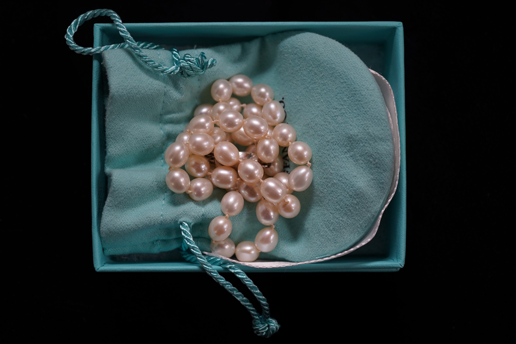 Tiffany & Co., a pair of diamond earrings and a cultured pearl necklace, the earrings of cross design, set with brilliant-cut diamonds totalling approximately 0.30 carats, mounted in platinum, length approximately 0.7cm